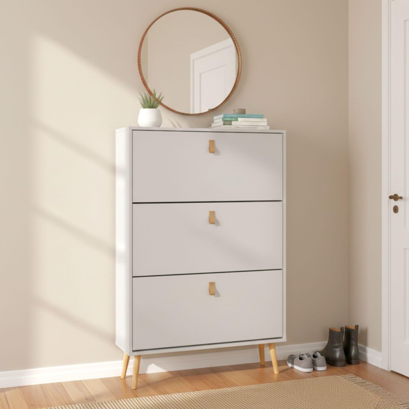 Cómoda blanca de tres cajones con asas de madera y patas de madera clara en ambiente de recibidor con espejo circular