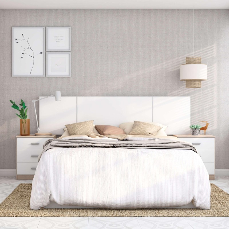 Cama blanca con cabecero acolchado y almohadas decorativas en dormitorio moderno