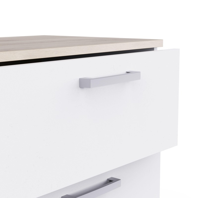 Detalle de cajonera blanca con tirador metálico y encimera en tonos naturales