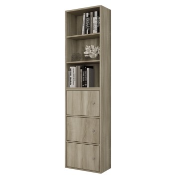 Estantería vertical de madera clara con tres estantes abiertos y tres puertas inferiores. Decorada con libros y adornos blancos.