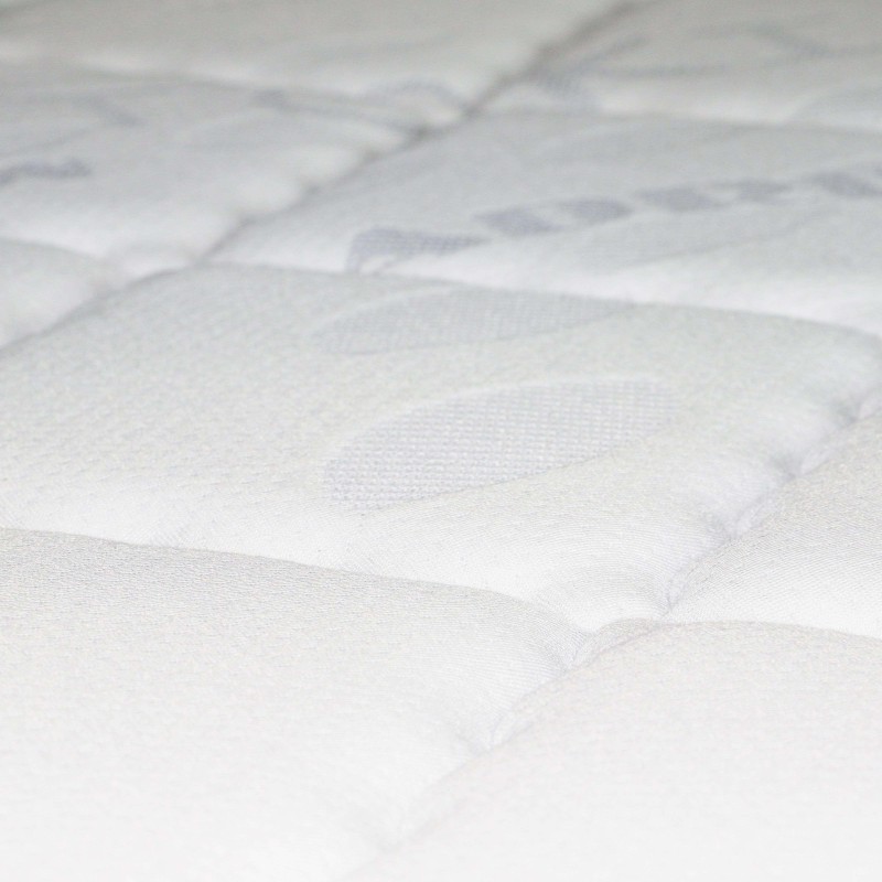 Detalle de colchón acolchado blanco con superficie con relieve y costuras decorativas