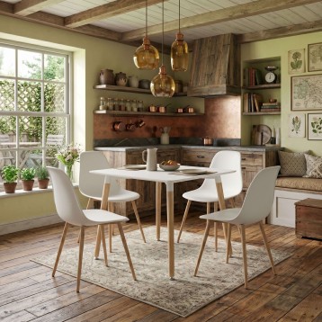 Comedor con mesa blanca rectangular y cuatro sillas blancas con patas de madera en ambiente de cocina rústica