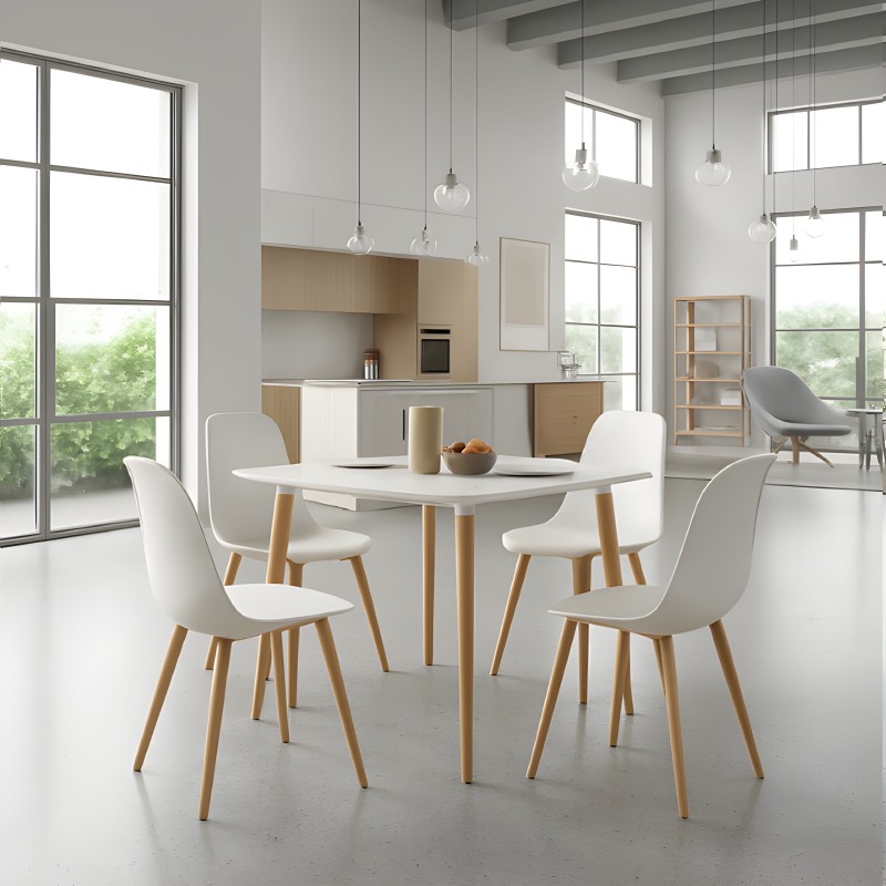 Comedor nórdico con mesa redonda blanca y cuatro sillas blancas de patas madera en ambiente moderno